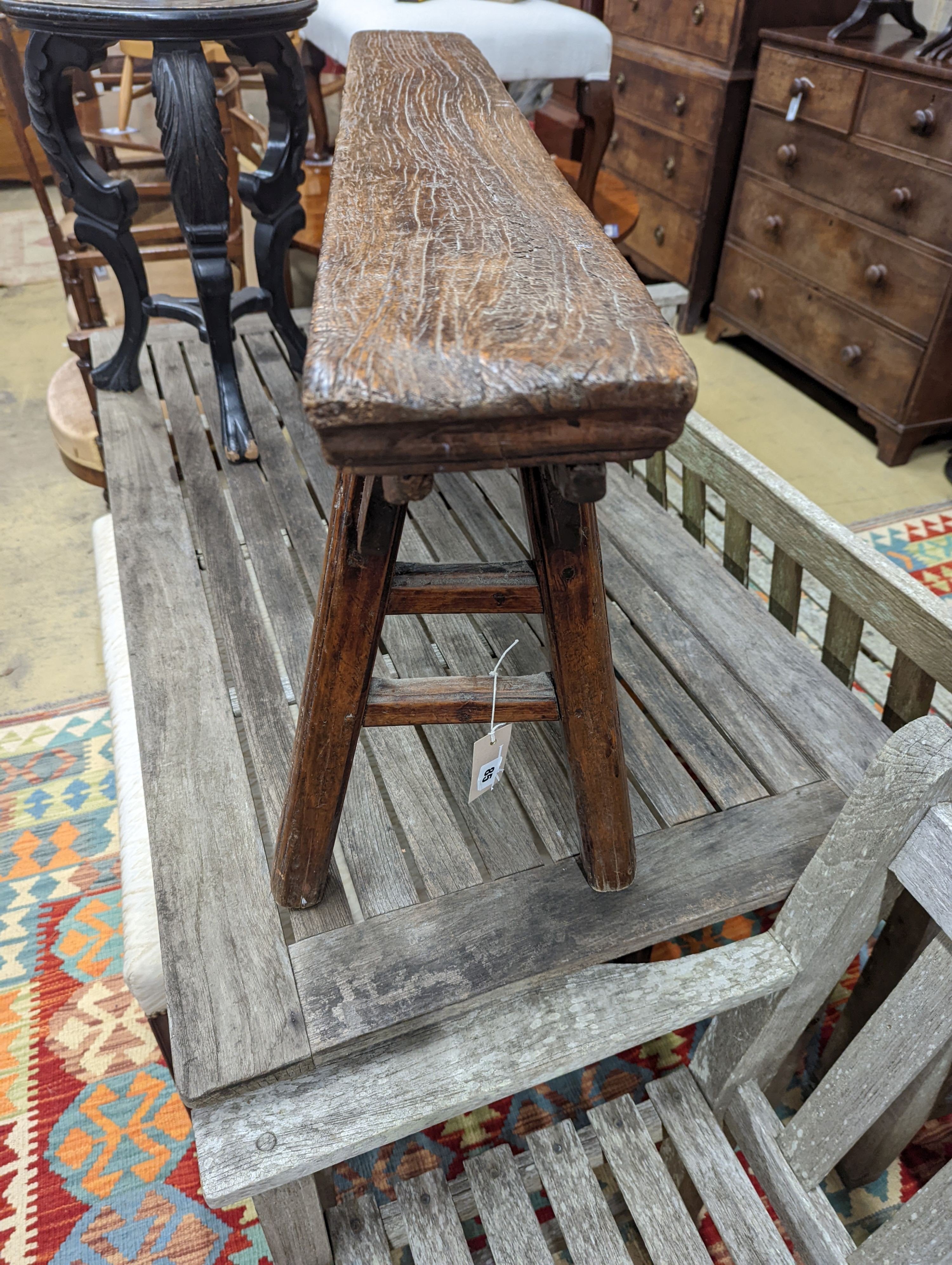 A Chinese elm bench, length 114cm, depth 29cm, height 51cm together with a circular ebonised vase stand